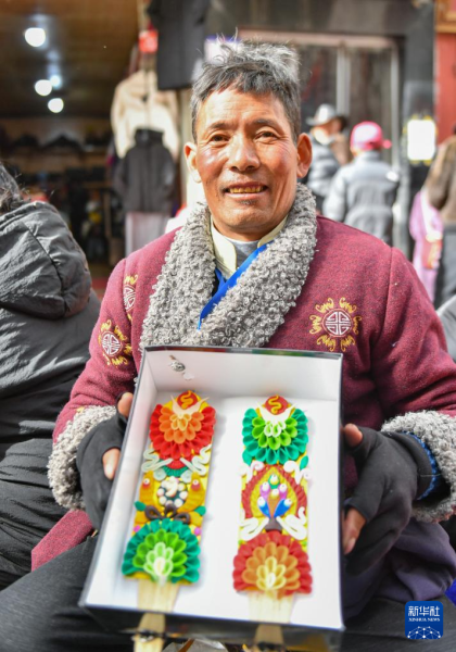 2月7日，在拉萨八廓商城，商贩在展示售卖的酥油花。