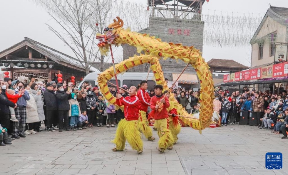 1月1日，游客在河北省遵化市兴旺寨镇一景区观看舞龙表演。新华社发（刘满仓 摄）