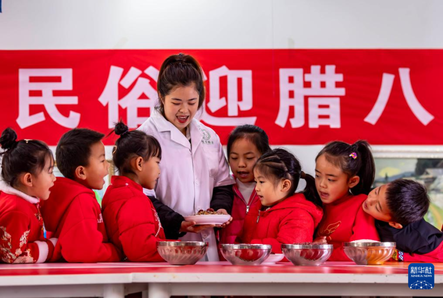 1月17日，在贵州省黔西市锦绣学校，老师和小朋友一起欢唱腊八歌。  新华社发（范晖 摄）