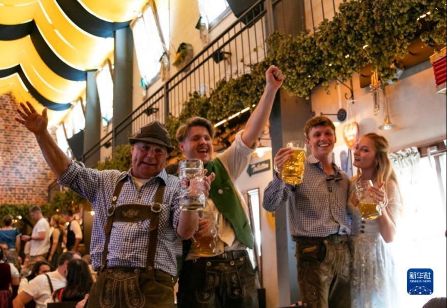 9月16日，人们在德国慕尼黑啤酒节上享用啤酒。新华社记者 张帆 摄